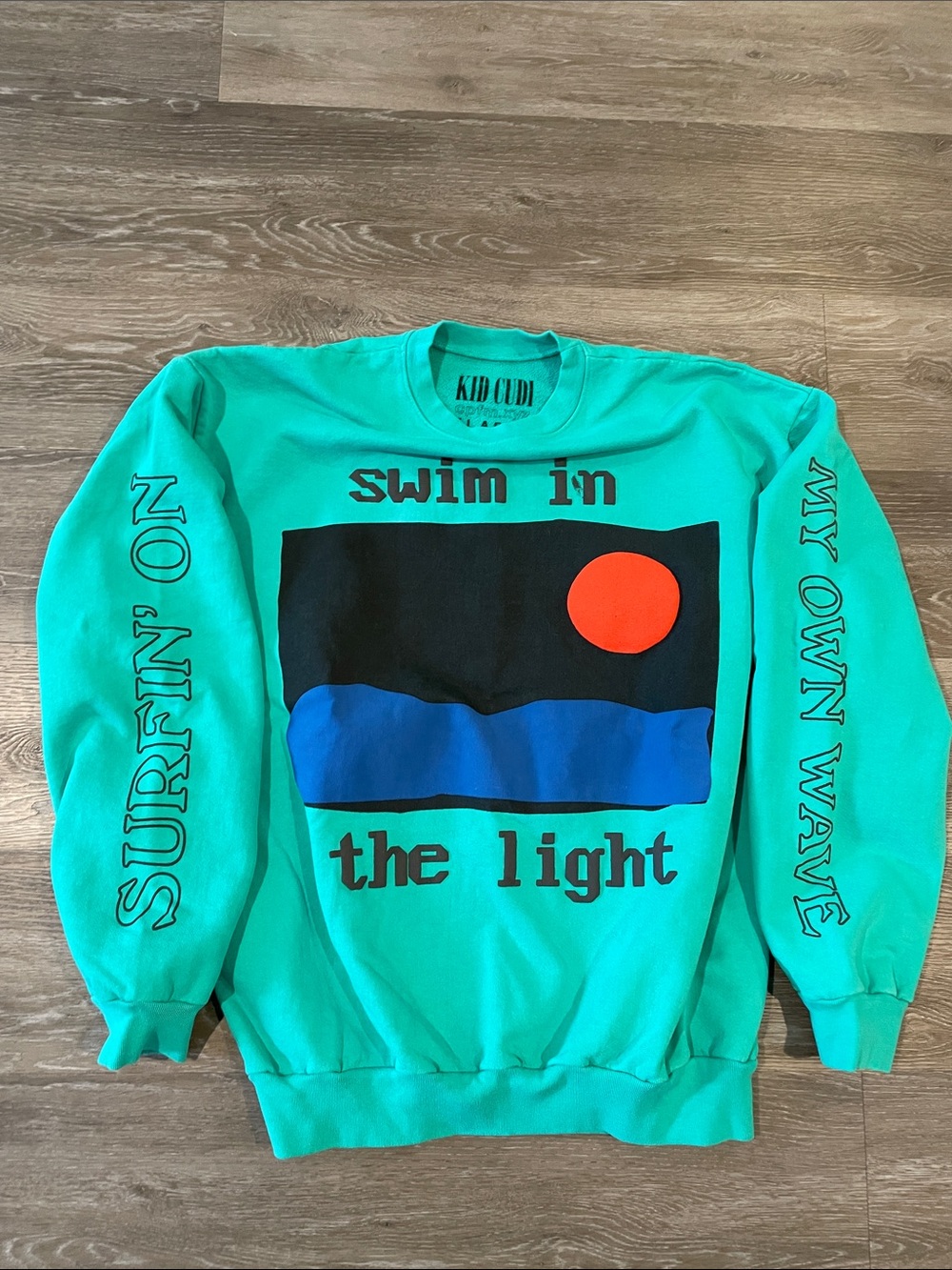 Cactus Plant Flea Market kid Cudi Teal Crewneck with Blue Wave & Orange Sun
